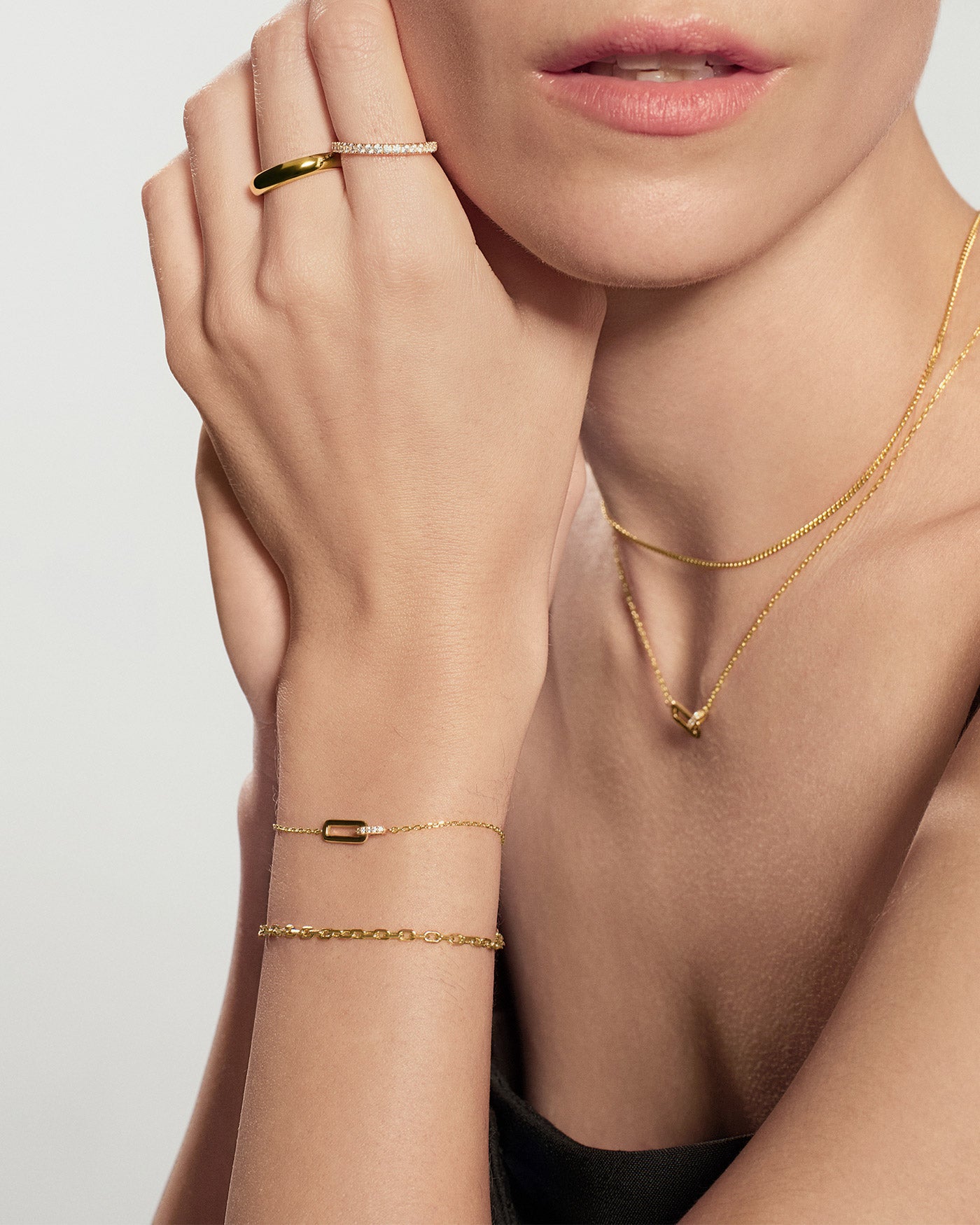 Gold Glam Interlock Bracelet worn on hand