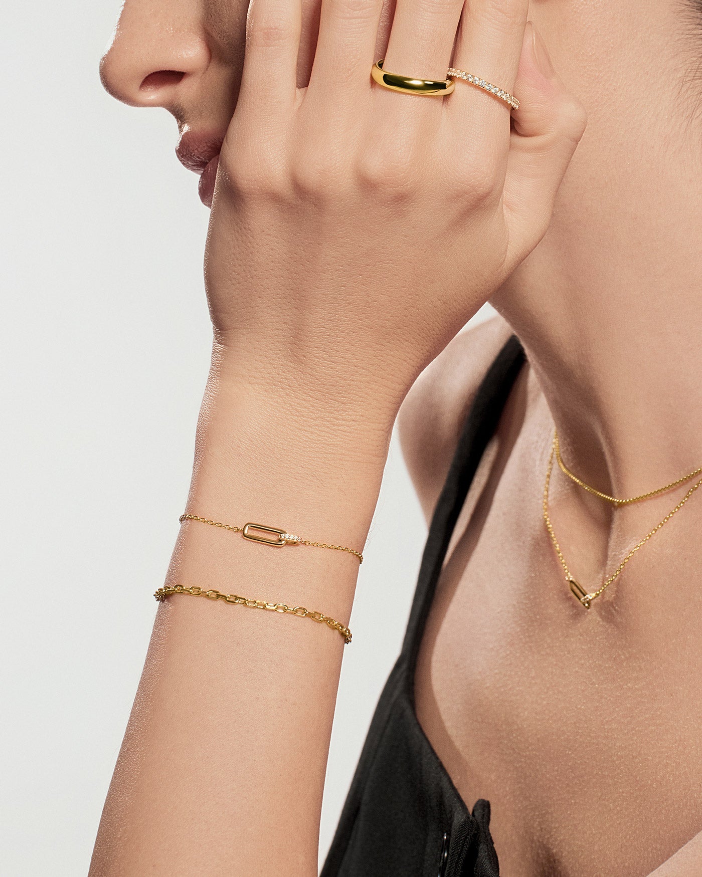 Gold pavé ring worn on hand with gold jewelry accessories