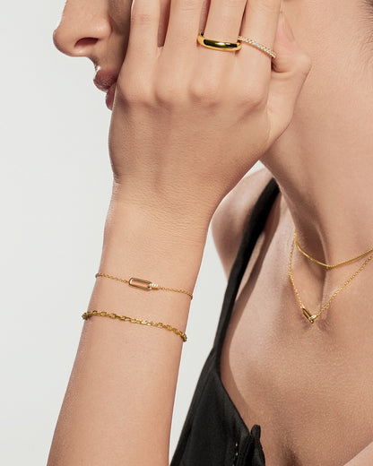 Gold pavé ring worn on hand with gold jewelry accessories