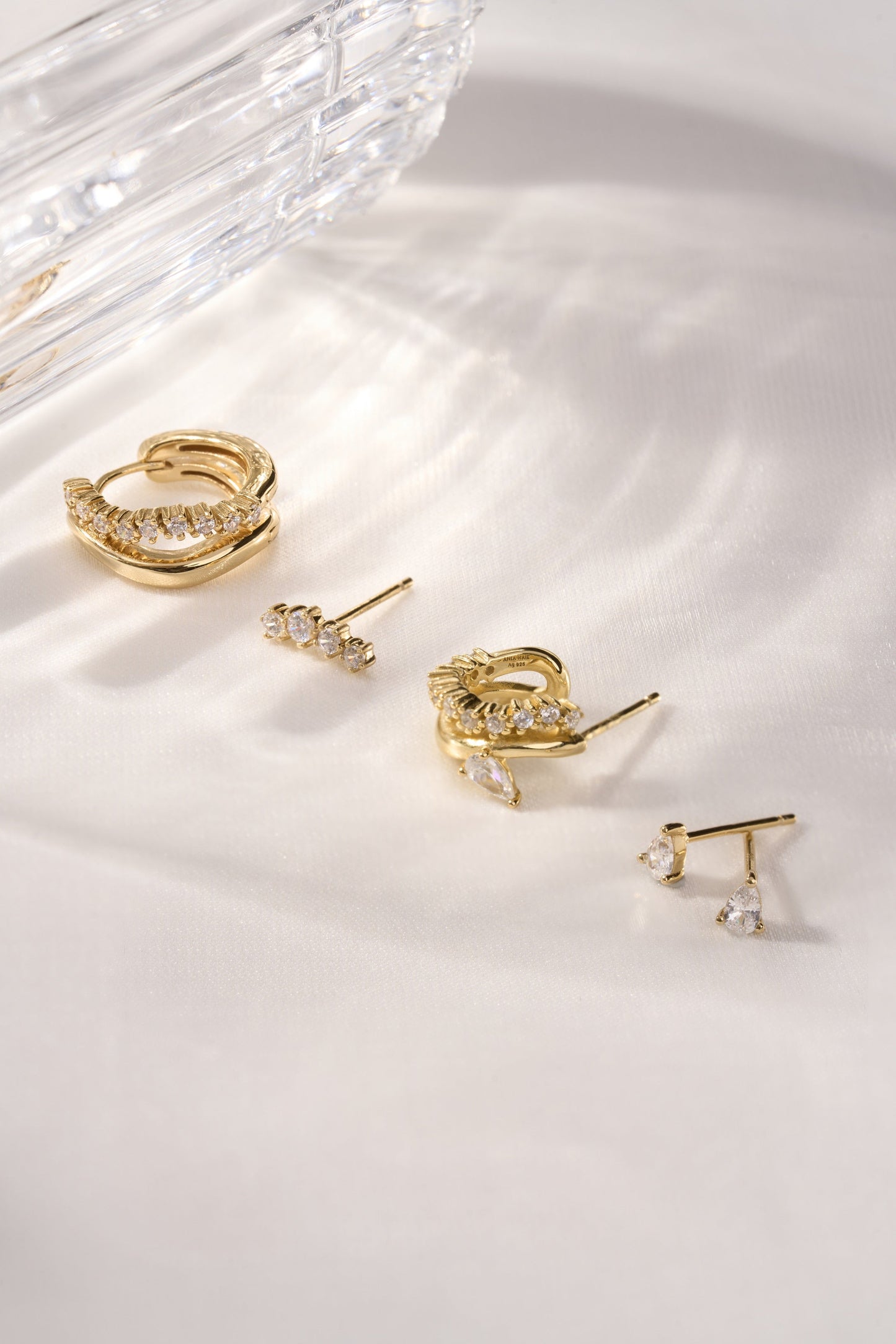 Gold sparkle crawler earrings lifestyle shot styled with multiple ear piercings