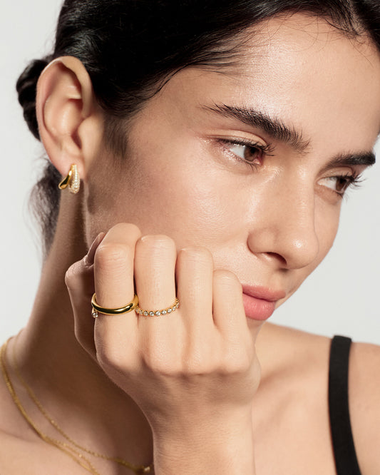Gold bezel set stackable ring worn on hand for women