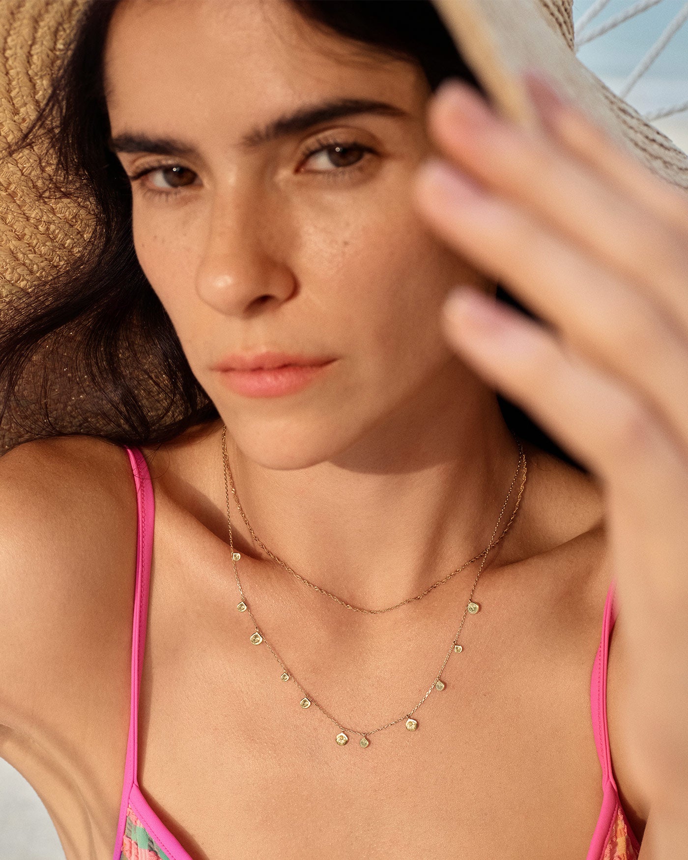 Close-up of gold mixed discs necklace worn with modern outfit