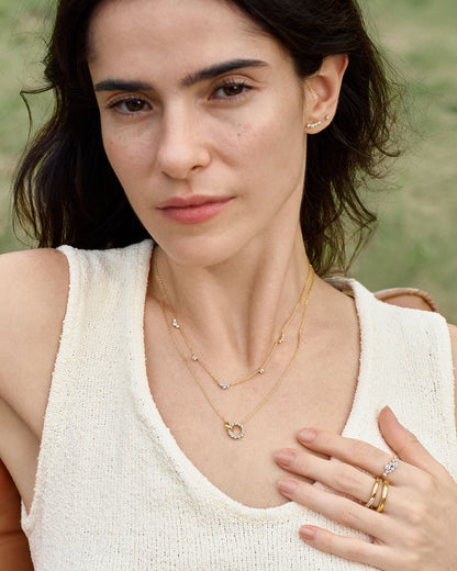 gold flower cluster ring styled with stacking bands on fingers