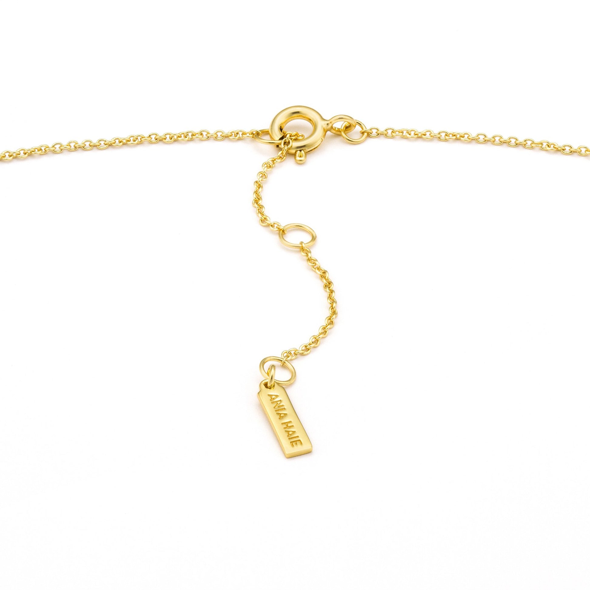 gold necklace featuring secure clasp closure detail